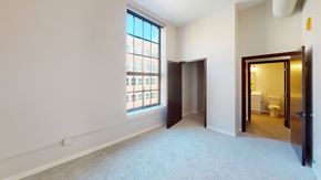 Duluth apartment for rent - A room with a carpeted floor and a window with a view of a building outside.