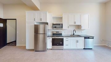 Duluth apartment for rent - A kitchen with white cabinets and stainless steel appliances.