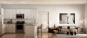 Charlotte apartment for rent - A modern kitchen with white cabinets and a large painting on the wall.