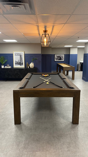 Duluth apartment for rent - A pool table in a room with a light hanging from the ceiling.