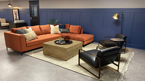 Duluth apartment for rent - A living room with a blue wall and a large orange sofa.