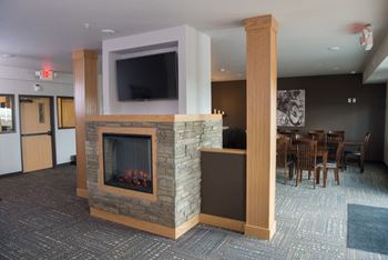 Community room with fireplace, large tv’s, bar/kitchen for entertainment