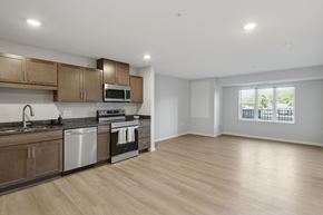 Fridley apartment for rent - A kitchen and living room at Callisto Commons in Fridley, MN.