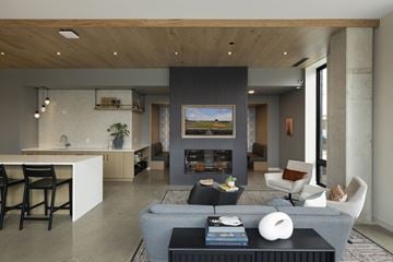 St. Paul apartment for rent - A modern living room with a grey sofa and a fireplace.