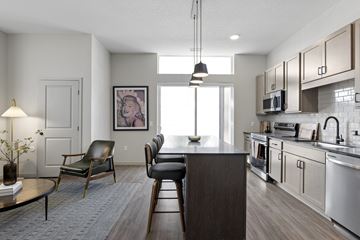 Chanhassen apartment for rent - A modern kitchen with a dining table and chairs.