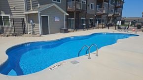 Rapid City apartment for rent - a swimming pool in front of an apartment building