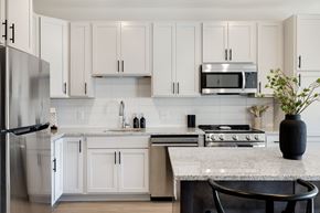 Shakopee apartment for rent - A kitchen with white cabinets and a granite countertop at The Blakeley in Shakopee, MN.
