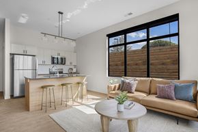 Salt Lake City apartment for rent - A modern living room with a bar area and a couch at The Whitney in Salt Lake City, Utah.