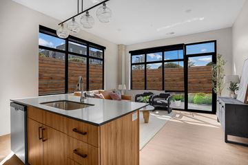 Salt Lake City apartment for rent - A modern kitchen with wooden cabinets and a stainless steel sink.