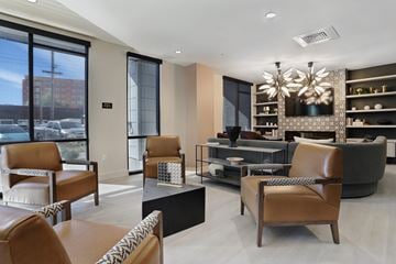 Salt Lake City apartment for rent - A modern living room with brown leather chairs and a black coffee table.