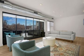 Salt Lake City apartment for rent - A living room with a grey couch and a green chair.