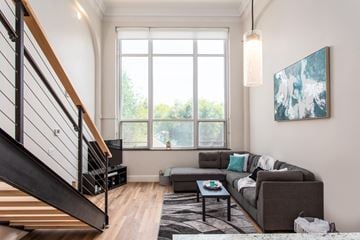 Cloquet apartment for rent - A living room with a couch, a coffee table, and a painting on the wall.