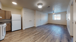 Cedar City apartment for rent - an empty kitchen and living room with white appliances and wood floors