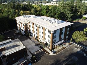 Tigard apartment for rent - an aerial view of a four story building with a white roof
