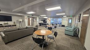 Nampa apartment for rent - A conference room with a couch, chairs, and a table.