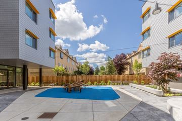 Portland apartment for rent - A modern building with a blue pool in the courtyard.