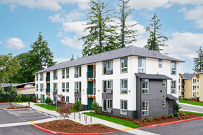 Portland apartment for rent - A modern apartment building with a parking lot in front.