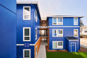 Portland apartment for rent - A blue building with white windows and a balcony.
