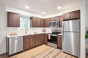 Mill City apartment for rent - a kitchen with stainless steel appliances and wooden cabinets
