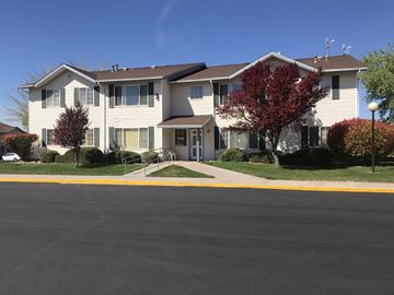 Hurricane apartment for rent - an apartment building with a sidewalk in front of it