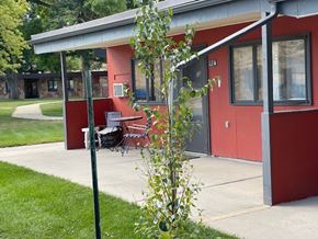 Thermopolis apartment for rent - A red building with a white door and windows.