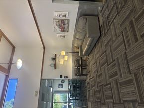 Billings apartment for rent - A room with a brown patterned wallpaper and a ceiling fan.