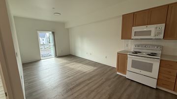 Hillsboro apartment for rent - A kitchen with a white oven and microwave above it.