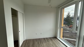 Hillsboro apartment for rent - A room with a large window and wooden flooring.