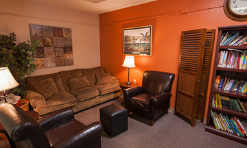 Hillsboro apartment for rent - a living room with a couch and chairs and a book shelf