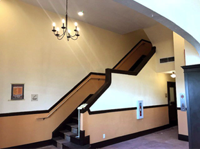 Astoria apartment for rent - A staircase with a chandelier hanging above it.
