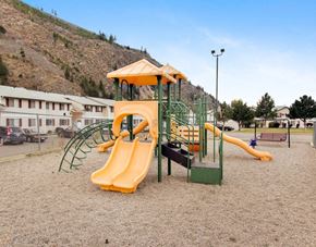 Missoula apartment for rent - A playground with a yellow slide and a green structure.