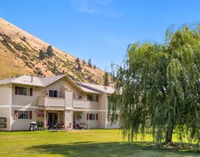 Missoula apartment for rent - Apartments with a balconies and a tree in front of it.