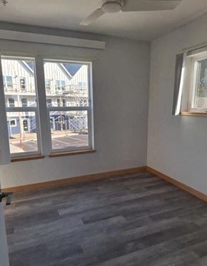 Lincoln City apartment for rent - A room with a grey floor and a window overlooking a parking lot.