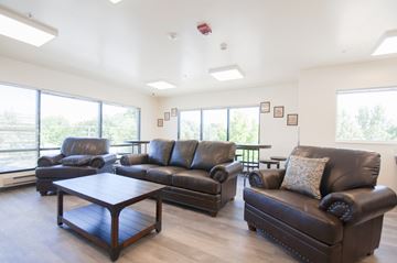 Boise apartment for rent - a living room with leather couches and a coffee table