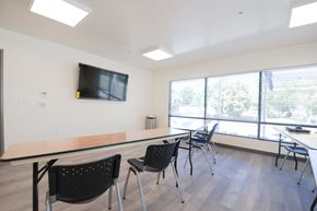 Boise apartment for rent - a conference room with tables and chairs and a television