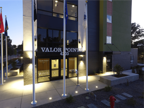 Boise apartment for rent - the facade of the valor pointe building at night