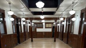Lewistown apartment for rent - a view down the hallway of a courtroom with wood paneling and white lights hanging from the