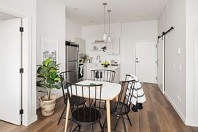 Saskatoon townhouse for rent - A kitchen with a table and chairs in the middle of the room.