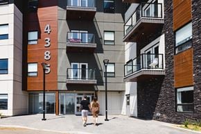 Saskatoon townhouse for rent - a man and a woman walking in front of a building