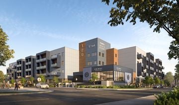 Saskatoon townhouse for rent - A modern building complex with a variety of businesses including a hotel and a restaurant.