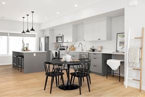 Saskatoon townhouse for rent - A modern kitchen with a dining table set for two.