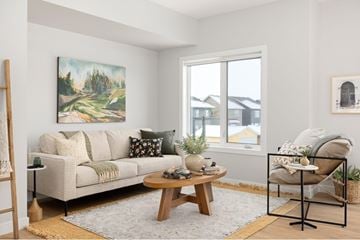 Saskatoon townhouse for rent - A living room with a couch, coffee table, and a painting on the wall.