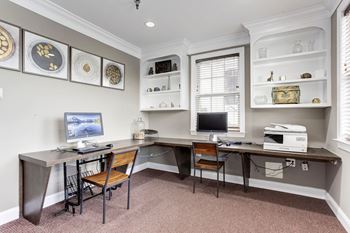A home office with two desks and a computer