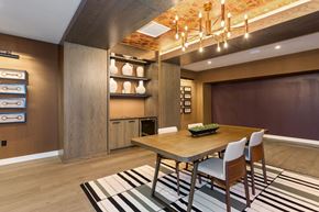 Ashburn apartment for rent - a dining room with a wooden dining table and white chairs on top of a black and white at Vyne One Loudoun, Virginia