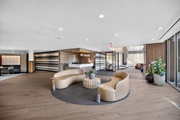 Washington apartment for rent - A modern living room with a curved sofa and a coffee table.