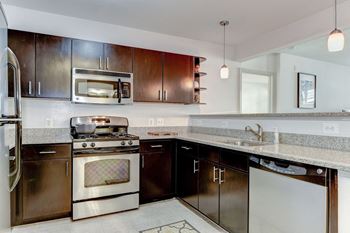 A kitchen with stainless steel appliances and granite counter tops