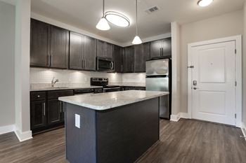 Fitted kitchen with island dining