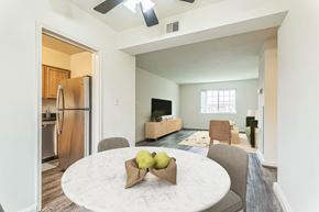 Silver Spring apartment for rent - A kitchen with a refrigerator and a dining table with chairs at The Fields of Silver Spring, Silver Spring