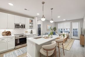 Chantilly apartment for rent - A modern kitchen with white cabinets and a large island. at The Sully, Virginia, 20151