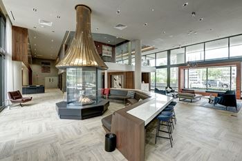 A large clubhouse with a fireplace and a large table and chairs